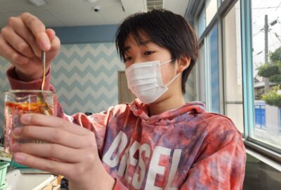 Grade 6 child Using a Science beaker in Science class at OWIS Osaka