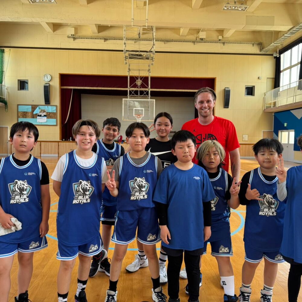 OWIS Osaka Blue Royals Basketball competative sports team, standing in newly renovated gymnasium, with professional sports coach